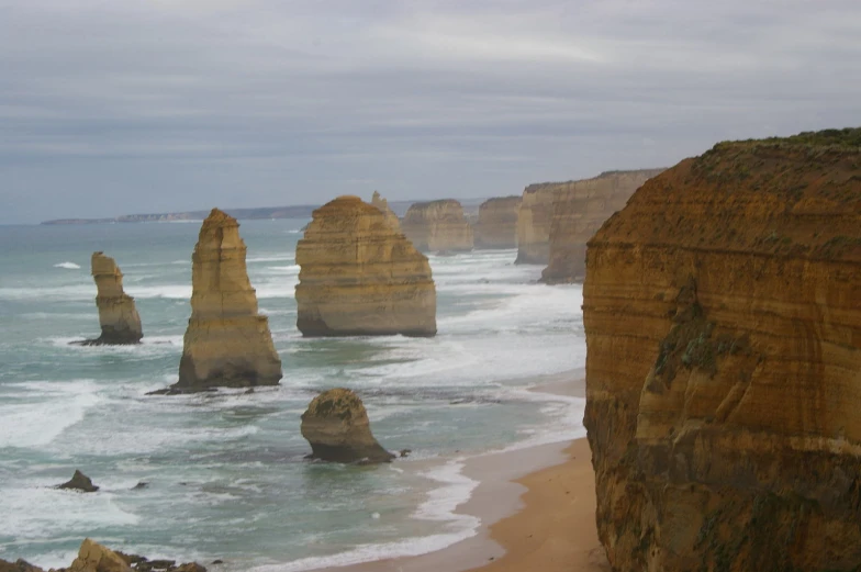 the twelve stones formations along a cliff with sea crashing against them