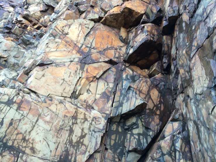 a large pile of rocks sitting on the side of a mountain