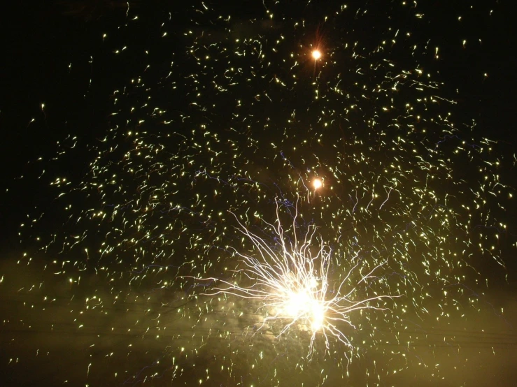 a big firework exploding in the night sky