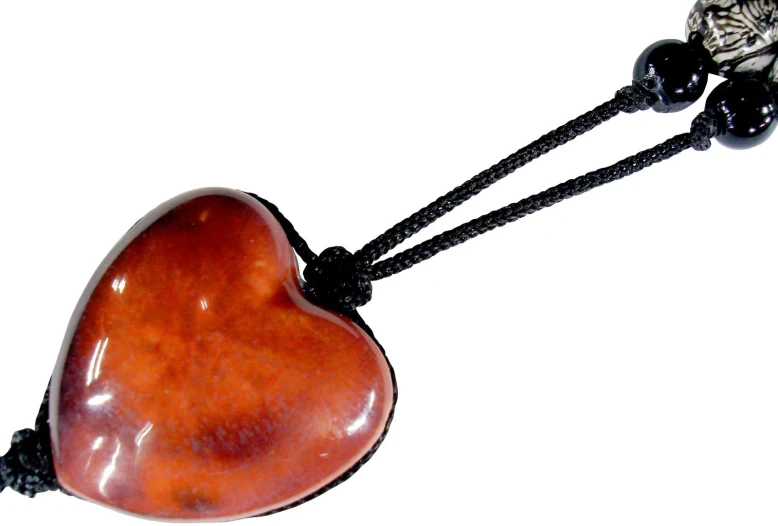 a heart shaped wooden bead hangs on a black cord