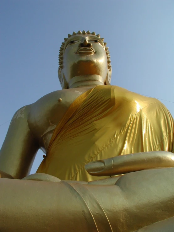 a large gold statue is sitting on the ground