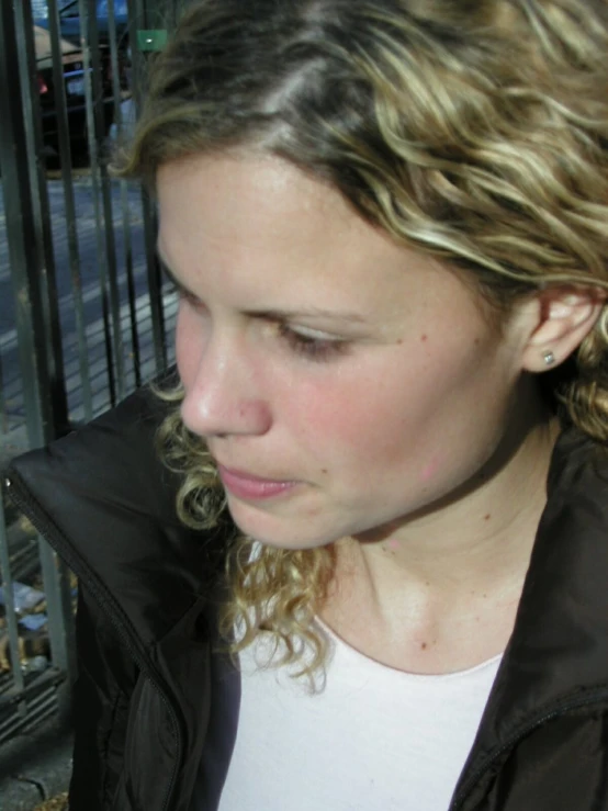 a woman with long hair eating a  dog