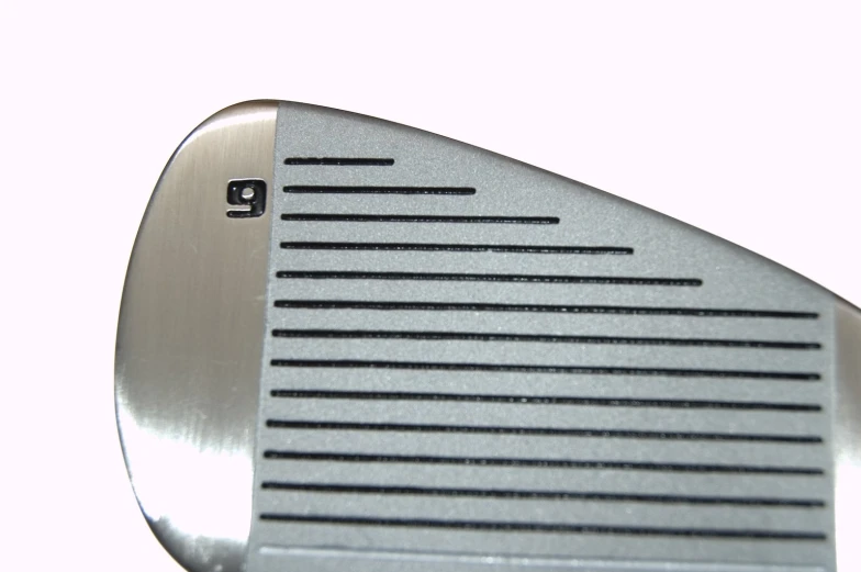 a close up view of the back of a wedged golf club