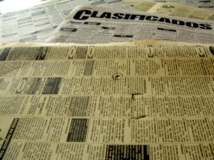 a close up of newspapers with some writing on it
