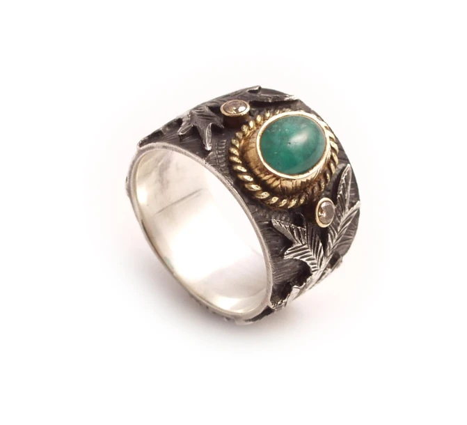 the ring is displaying a green stone and two yellow leaves