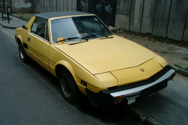 a yellow car parked on the side of a street