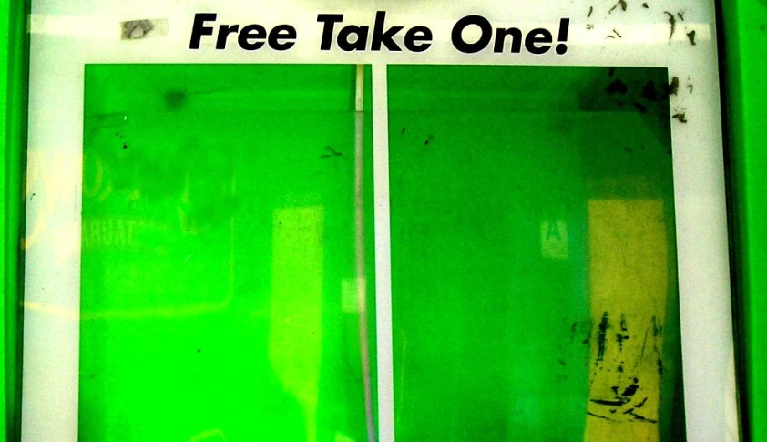 a close up of a sign on a door that says free take one