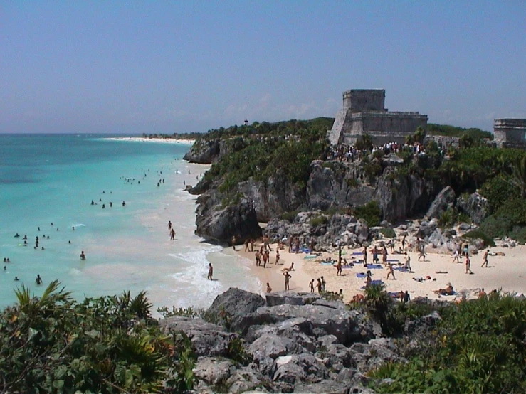 a beach in mexico with people in it
