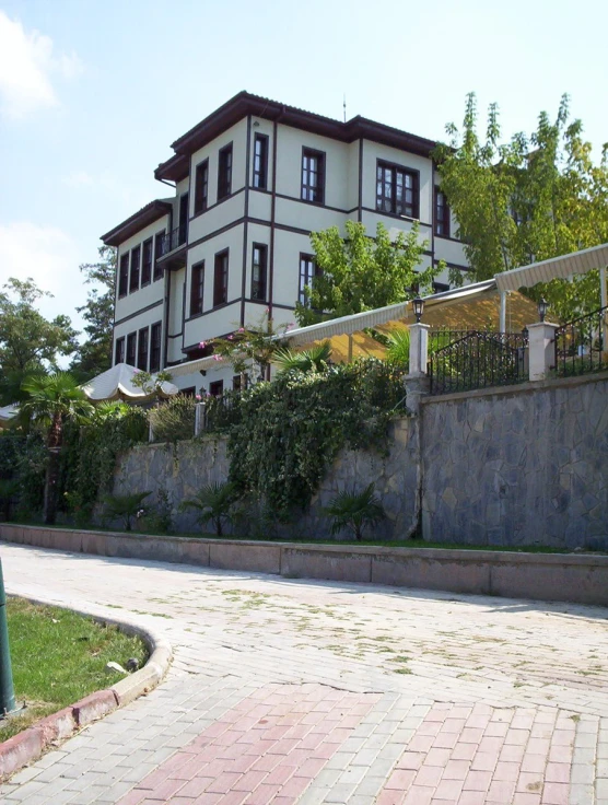 a house is surrounded by greenery and shrubs