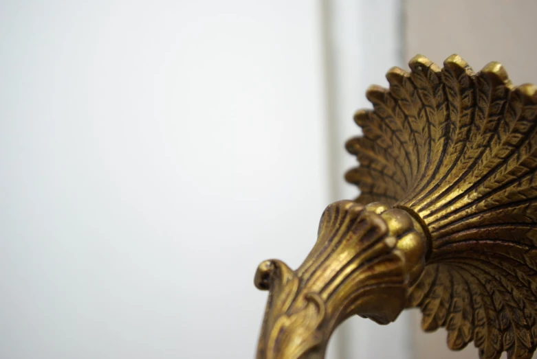 a gold - colored plant shaped mirror in an apartment room