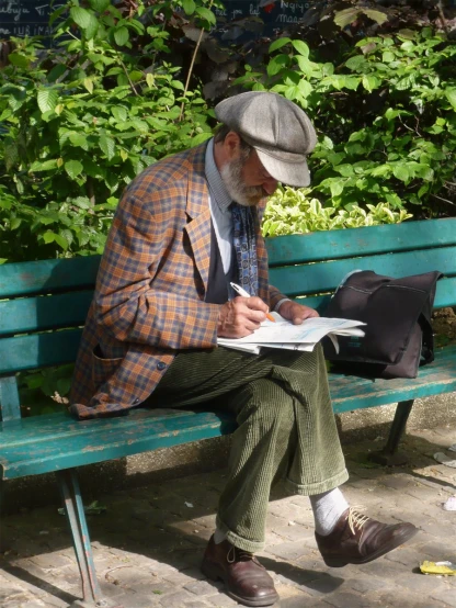 a man writing in his notebook on a bench