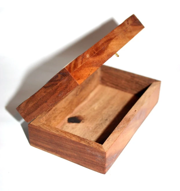 small wooden box that holds soing on the inside