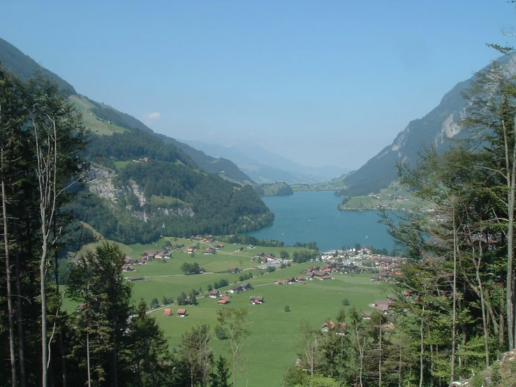 an aerial view looking down on some mountains and a lake