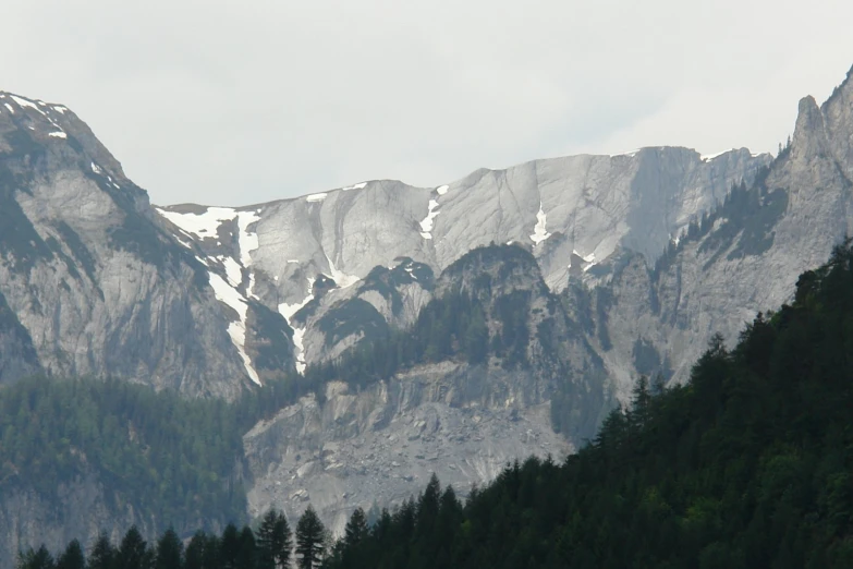 mountains with a snow - capped top are in the foreground