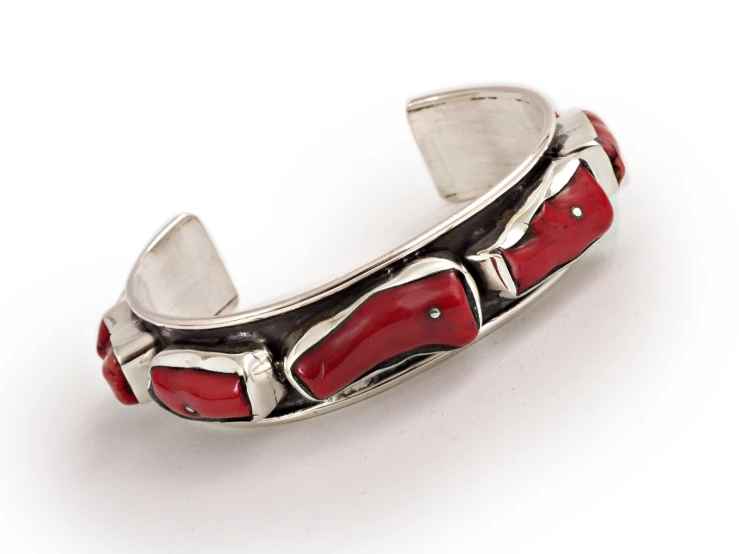 a silver celet with red stones on it