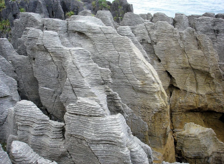 many rock formations near the water