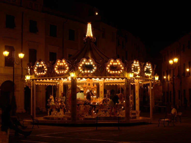 a merry go round on a nighttime city street