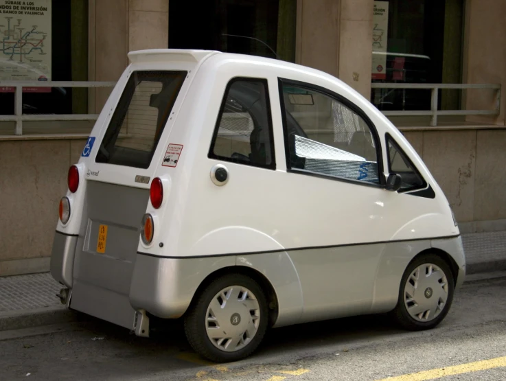 a small electric car parked on the side of a street