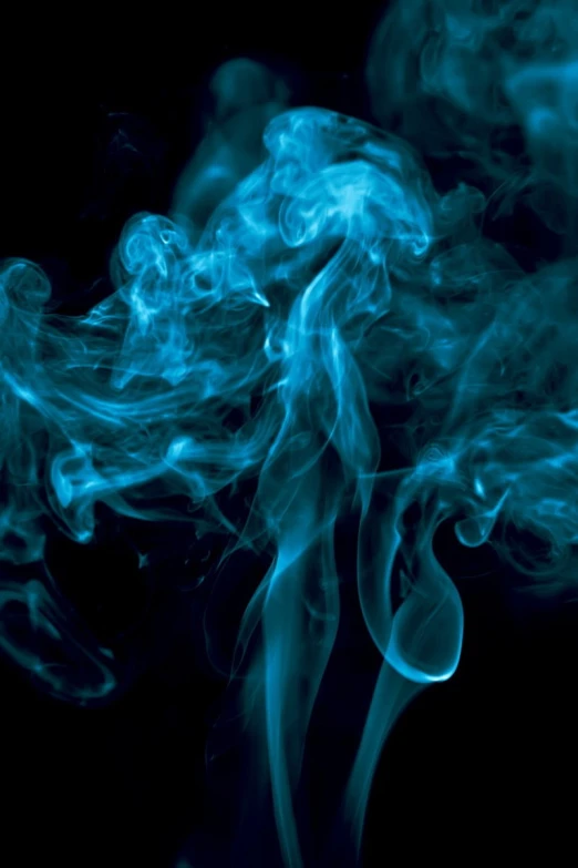 a very beautiful blue smoke is flying through the air