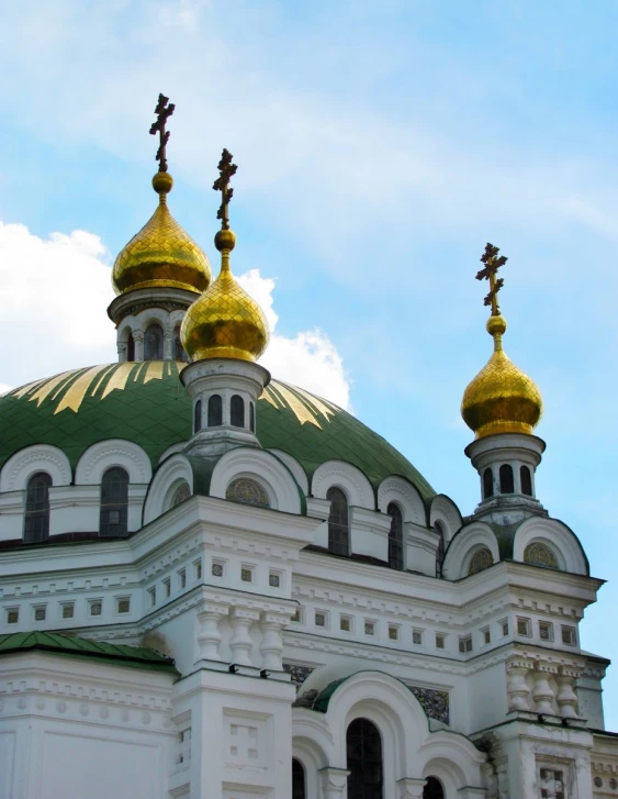 a building with two golden crosses and towers