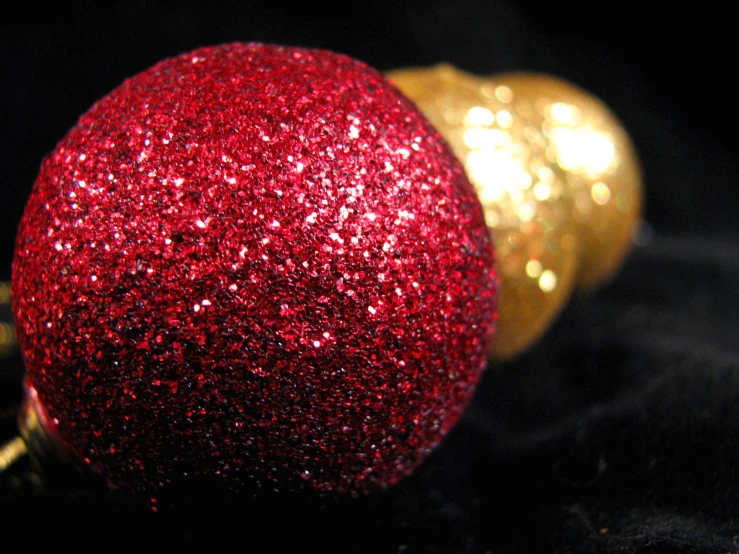 the red ornament is beside the gold bottle