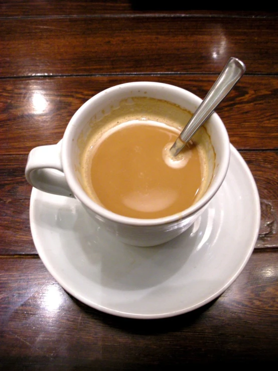 a white plate topped with a cup of coffee