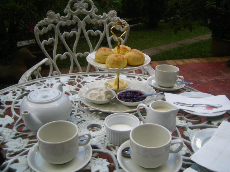 a table with plates of food and tea on it