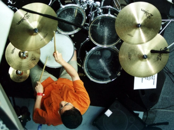 an overhead view of man playing drums while looking down