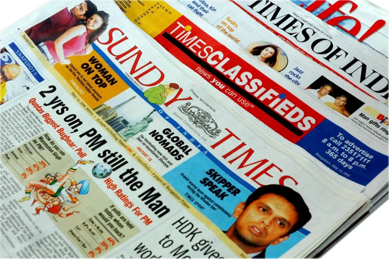 a pile of newspapers from various countries laying together