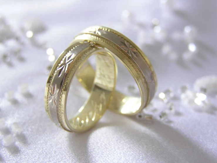 two gold wedding bands next to each other
