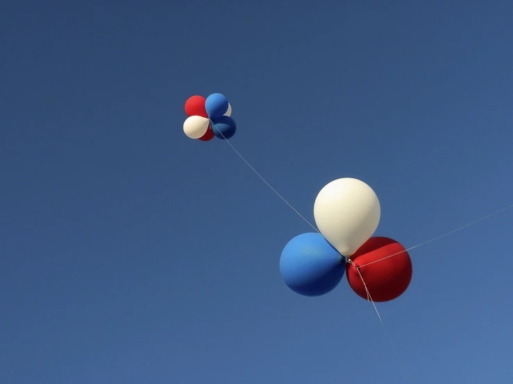 a group of balloons flying in the air
