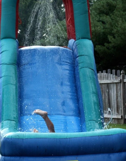 the pool with a slide is filled with water