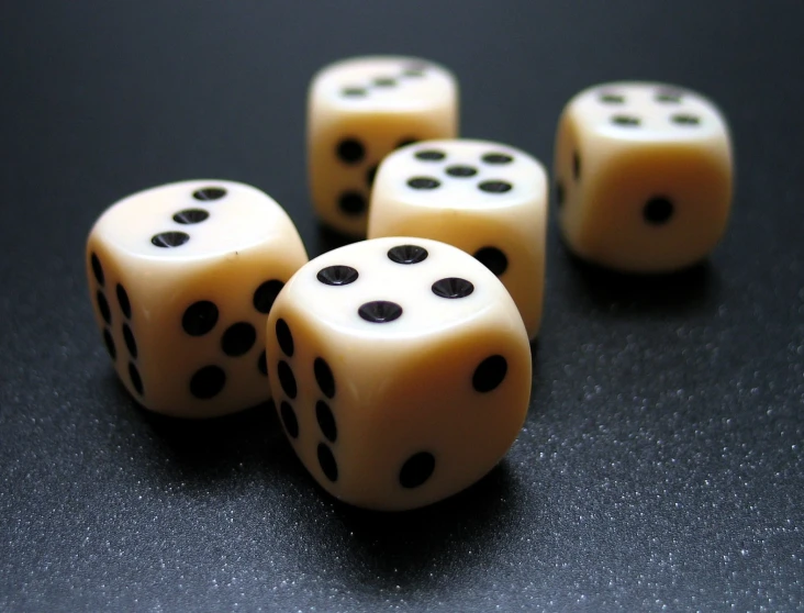five white dice laying side by side on top of a table