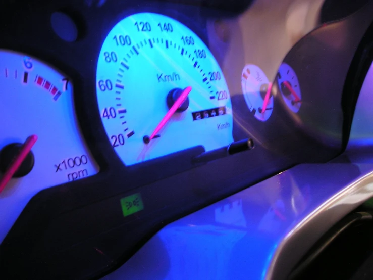 the dash lights of the car have red and white numbers