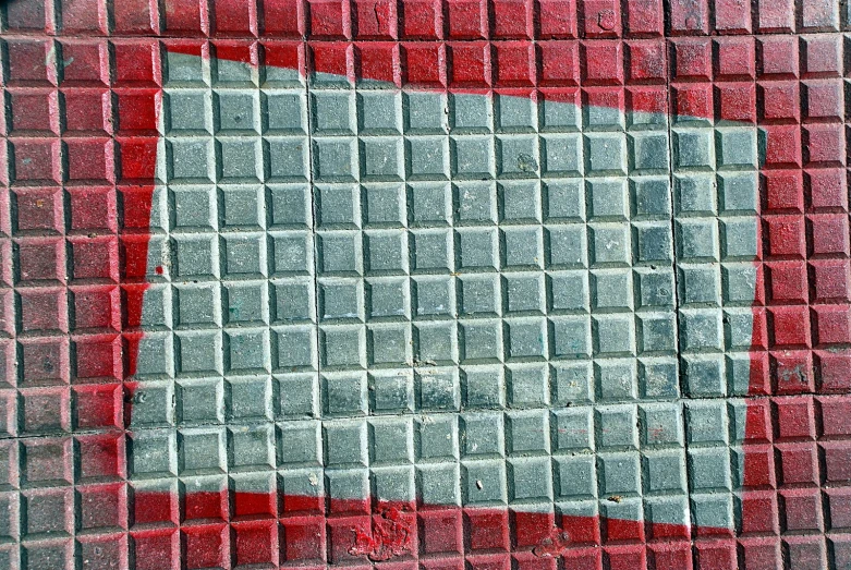 the tiled wall has a red triangle on it