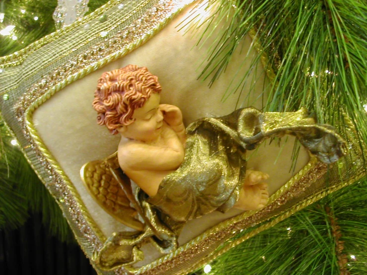 a little christmas ornament that has an angel on top of it