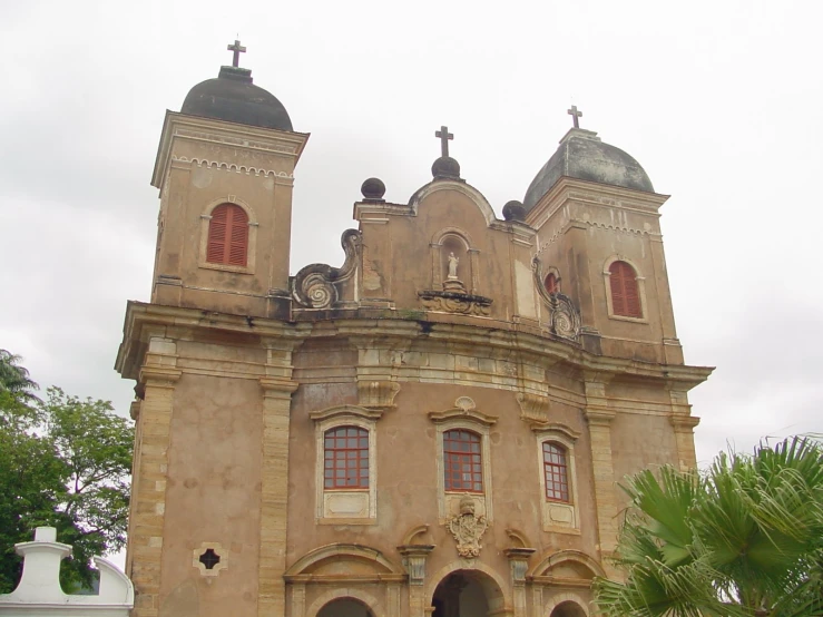 a very tall cathedral type building with a cross on the top of it