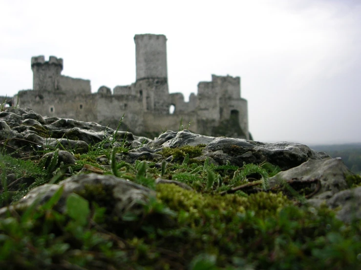 a large stone structure sitting on top of a lush green hillside