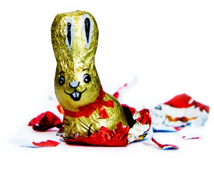 a bunny sitting on the ground with a tinsel