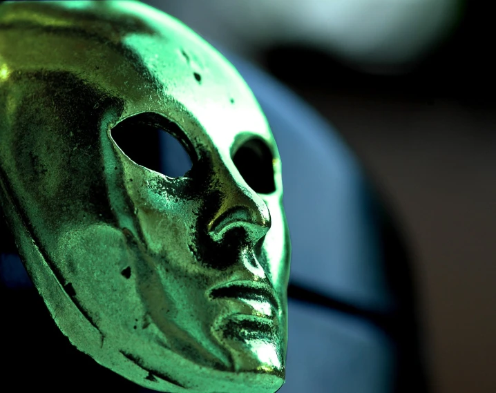 a mask sits in the foreground of a pograph