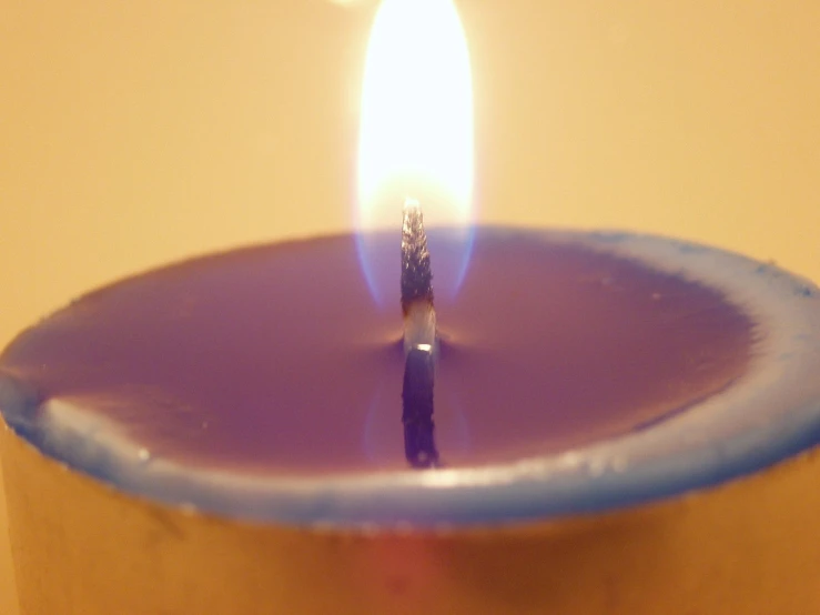 a candle is lit on an yellow background