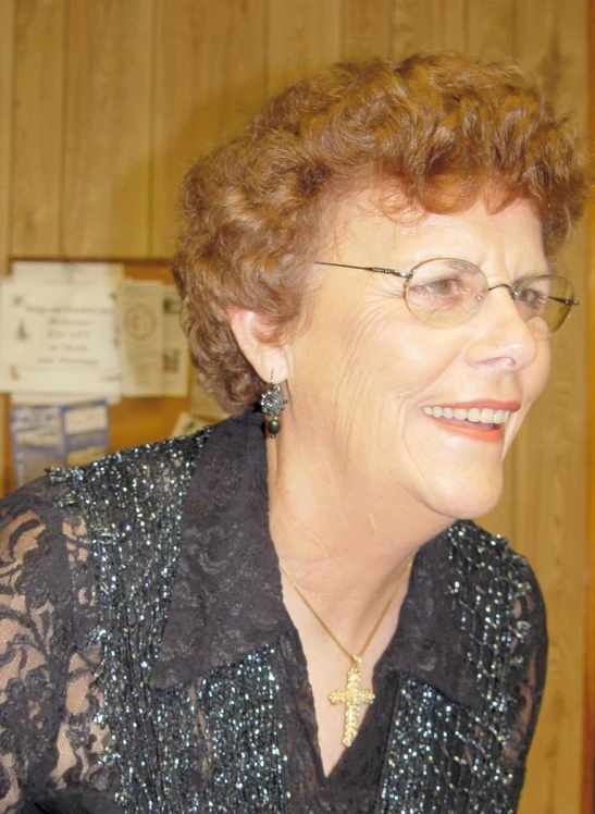 woman smiling while wearing glasses in office setting