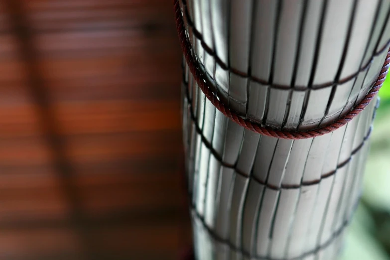 the vase is white with burgundy lines and brown spots