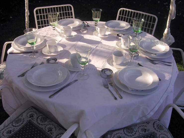 there is table set up for three at this outdoor event