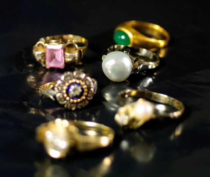 an assortment of rings and ring settings are laid out