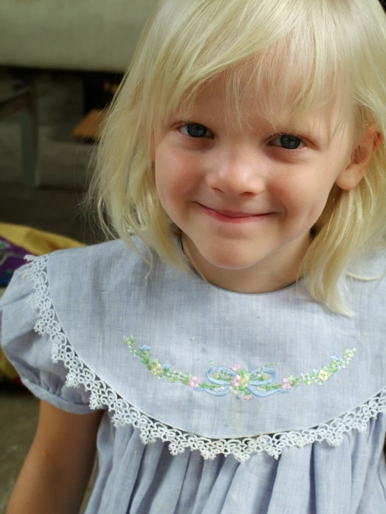 this little girl smiles brightly for the camera