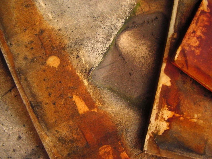 two rusty pieces of metal sit on the ground