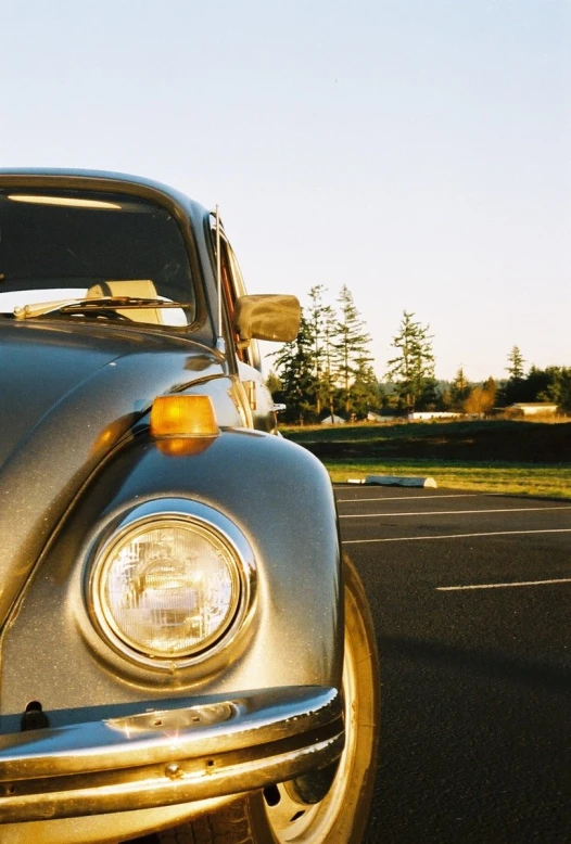 the front of a shiny car that is on the road