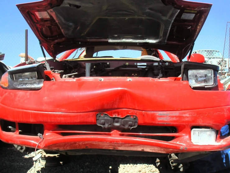 a red sports car with its hood up