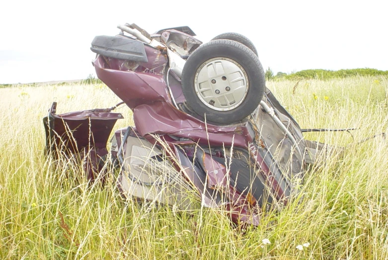 a red motorcycle sitting in the middle of a field